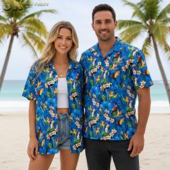 Blue floral hawaiian shirt with white plumeria flowers, orange bird-of-paradise blooms, and tropical bird motifs