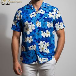 Blue floral Hawaiian shirt with white plumeria flower pattern arranged on blue background fabric