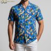 Blue hawaiian shirt displaying tropical parrots and toucans with colorful floral elements and green foliage