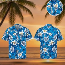Blue hawaiian shirt featuring white hibiscus flowers, tropical leaves, and turtle graphics on bright blue background