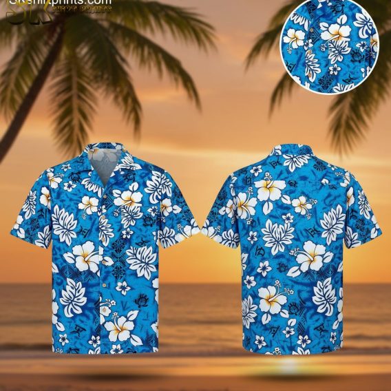Blue hawaiian shirt featuring white hibiscus flowers, tropical leaves, and turtle graphics on bright blue background
