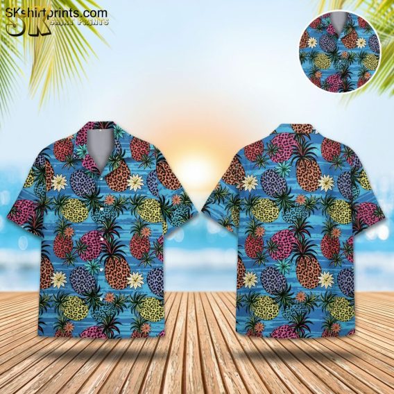 Blue pineapple Hawaiian shirt featuring colorful pineapples with leopard spots in orange, pink, yellow and purple