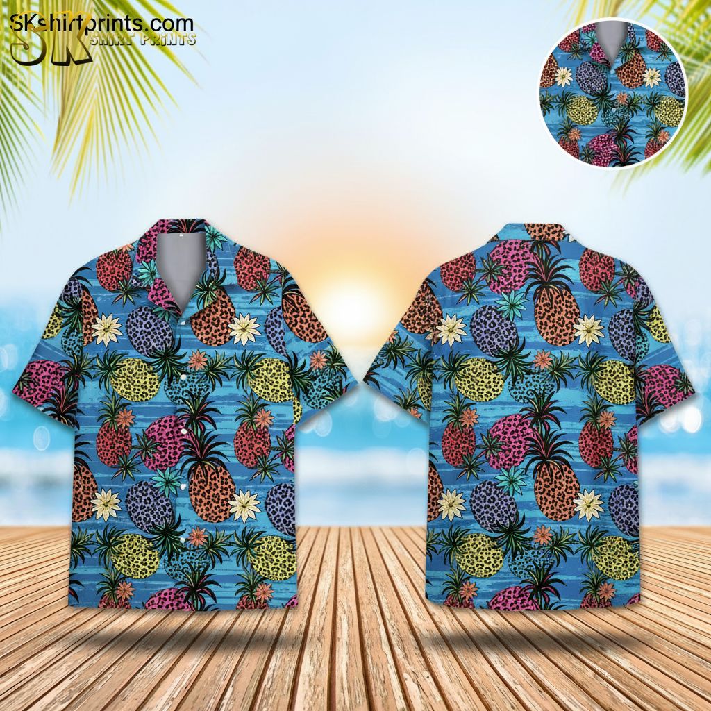 Blue pineapple Hawaiian shirt featuring colorful pineapples with leopard spots in orange, pink, yellow and purple