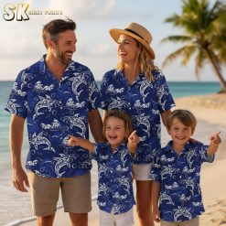 Blue tropical shirt featuring stylized white dolphins and ocean waves with artistic line patterns and bubble accents