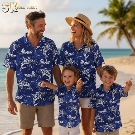 Blue tropical shirt featuring stylized white dolphins and ocean waves with artistic line patterns and bubble accents