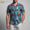 Blue tropical shirt displaying pineapples and hibiscus flowers with tropical leaves on ocean-themed background