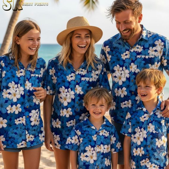 Blue tropical shirt featuring white plumeria flowers with yellow centers in scattered tropical pattern