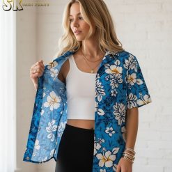 Blue tropical shirt showing white hibiscus flowers, large tropical leaves, and small turtle illustrations