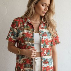 Christmas aloha shirt displaying Santa riding motorcycles with palm trees and beach huts scattered throughout