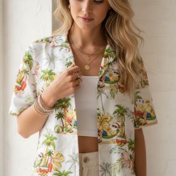 Christmas in july hawaiian shirt with beach scene pattern featuring palm trees, surfboards, hibiscus flowers, hammock, and beach balls