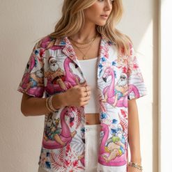Christmas themed Hawaiian shirt displaying tropical Santa illustrations with flamingo floats and vibrant flower patterns