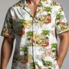 Christmas tiki shirt displaying tropical beach elements including palm trees, surfboards, hibiscus flowers, and beach scene motifs