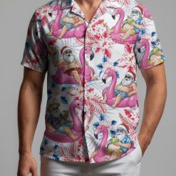 Christmas vacation Hawaiian shirt showing Santa in beach attire with sunglasses holding drinks on flamingo floats