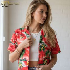 Dark red Hawaiian shirt worn casually, showing tropical print with palm trees and ocean scenes