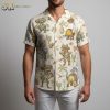 Close-up detail of dinosaur hawaiian shirt showing cartoon dinosaurs wearing sombreros with palm trees and guitar tropical pattern