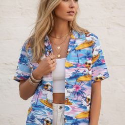 Donald Duck shirt for men showing ducks with sunglasses surfing on yellow boards with hibiscus flowers and ocean waves
