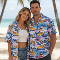 Duck Hawaiian shirt displaying cartoon ducks with necklaces surfing on yellow boards with tropical ocean scenery