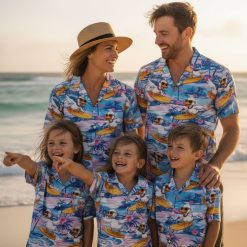 Duck print shirt with cartoon ducks wearing necklaces on yellow surfboards surrounded by palm trees and tropical flowers