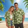 Green aloha shirt displaying botanical leaf print with flower clusters in cream tones