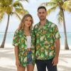 Green aloha shirt with dense tropical butterfly pattern featuring orange and yellow accents on green background