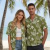 Green aloha shirt displaying white tropical flowers and monstera leaf patterns