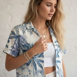 Light blue hawaiian shirt with tropical palm tree design and decorative border elements