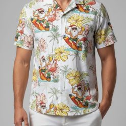 Matching Christmas Hawaiian shirt with Santa surfing design, hibiscus flowers, and tropical elements for family coordination