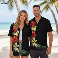 Mens black Hawaiian shirt displaying red hibiscus flowers with yellow plumeria and tropical foliage