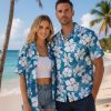 Mens blue Hawaiian shirt with white hibiscus flowers and blue leafy background pattern