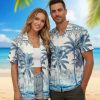 Mens blue hawaiian shirt with tropical palm tree pattern and decorative floral border design