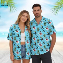 Mens blue hawaiian shirt displaying toucans on rifles with flamingo and tiki mask elements