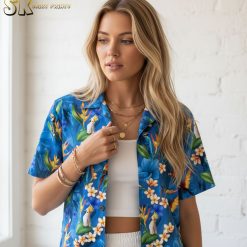 Mens blue hawaiian shirt with colorful tropical birds including parrots and toucans among blue flowers and green leaves