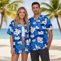 Men's blue Hawaiian shirt with white tropical flowers and yellow centers on blue fabric