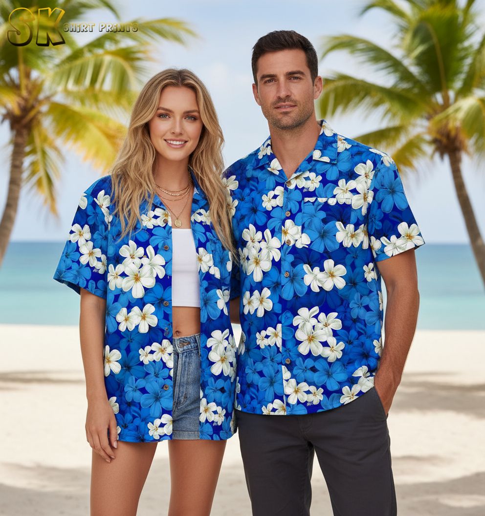 Men's blue Hawaiian shirt with white tropical flowers and yellow centers on blue fabric