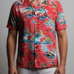 Close-up view of men's red tropical shirt showing detailed Hawaiian print with ocean scenes and palm trees
