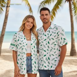 Mens white Hawaiian shirt displaying green tropical leaves and natural motifs