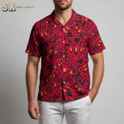 Close-up detail of red black Hawaiian shirt showing intricate abstract patterns with flame-like yellow accents