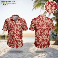 Red floral Hawaiian shirt with cream hibiscus flowers worn by man in lifestyle setting