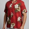 Red Notice Ryan Reynolds Hawaiian shirt with white hibiscus and green leaf pattern on vibrant red fabric