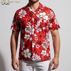 Close-up detail of red white and blue Hawaiian shirt showing white hibiscus flowers and tribal design elements