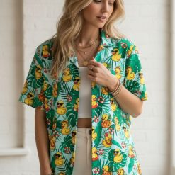 Rubber duck button up shirt displaying ducks with accessories on tropical leaf background