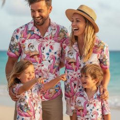 Surfing Santa Hawaiian shirt featuring Santa in beach vacation mode with sunglasses on flamingo floats surrounded by tropical flowers