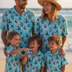 Tactical aloha shirt displaying gun graphics, flamingos with accessories, and tiki mask elements