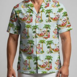 Tropical Christmas shirt displaying Santa in beach setting with palm trees, beach balls and string lights