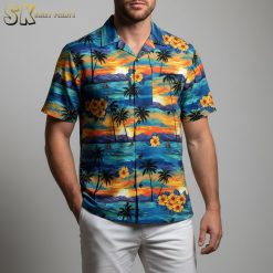 Tropical Hawaiian shirt displaying sunset sailboat scene with hibiscus flowers and beach elements