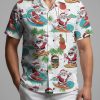 Tropical Santa shirt displaying Santa surfing with tiki masks, guitars and pink hibiscus pattern