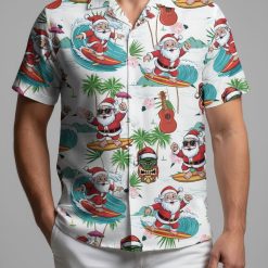 Tropical Santa shirt displaying Santa surfing with tiki masks, guitars and pink hibiscus pattern