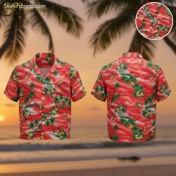 Vintage red Hawaiian shirt featuring green palm trees, yellow flowers, and sailboat scenes on bright red background
