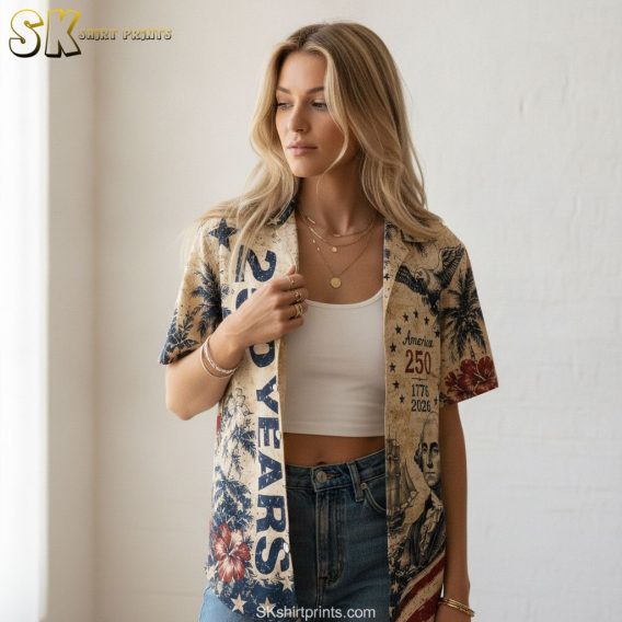 America 250th anniversary Hawaiian shirt with eagle, historical figure illustration, palm trees, hibiscus flowers, American flag, and 1776 2026 anniversary print in red, white, and blue.