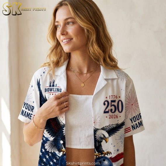 Women's bowling Hawaiian shirt with eagle holding a bowling ball, American flag background, stars and fireworks in red, white, and blue, shown in a close-up airy lifestyle photo.